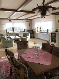 a living room with a wooden table and chairs at Ferienwohnung Susanna in Wascheid