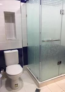 a bathroom with a toilet and a glass shower at Bright Guesthouse in the center of Yerevan! in Yerevan
