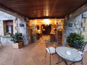 a patio with a table and chairs and a kitchen at La Casona del Carmen in Noja