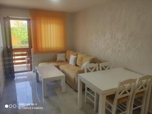 a living room with a couch and a table at Apartmani ODMOR NA DRINI in Ljubovija +30 photos