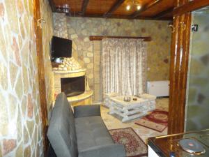 a living room with a couch and a television at KALAVRITA INN in Kalavrita