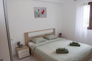 a bedroom with a bed with two pillows on it at Apartment Mara in Vižinada