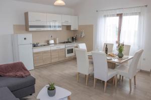 a kitchen and living room with a table and chairs at Apartment Mara in Vižinada +22 photos