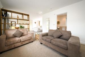 a living room with two chairs and a couch at Lakeside Old Hunstanton in Hunstanton