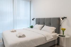 a bedroom with a large bed with towels on it at Deluxe Apartment in Top Tel Aviv Neighbourhood by Sea N' Rent in Tel Aviv