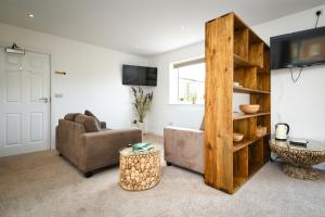 a living room with a couch and a table at Lakeside Old Hunstanton in Hunstanton