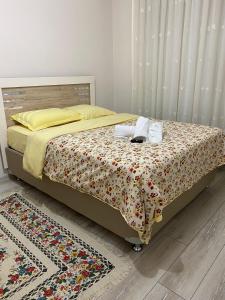 a bed with two towels on it in a bedroom at Emre Guest Apartment Near İstanbul Airport in Istanbul