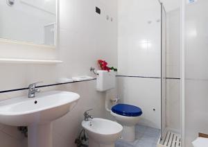 a white bathroom with a sink and a toilet at Residence Costa d’Otranto in Otranto +19 photos