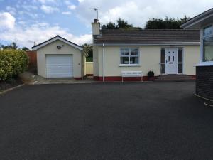 a house with a garage and a driveway at Glenrandel Valley in Claudy