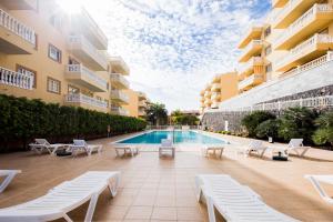 a swimming pool in the middle of a building at Palm Mar de LUX A32 in Palm-mar