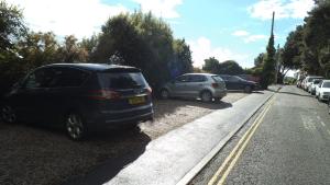 a row of cars parked on the side of a street at Lammas Park House in Dawlish