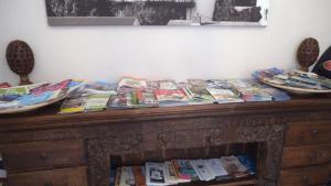 a wooden table with books on top of it at Lammas Park House in Dawlish