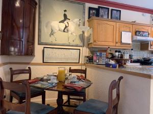 a dining room with a table and a horse picture on the wall at geraldsplace in Edinburgh