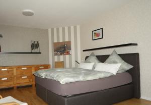 1 dormitorio con 1 cama grande con almohadas blancas en Villa Alta, en Bad Wildungen