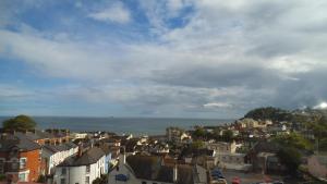 a view of a city with houses and the ocean at Lammas Park House in Dawlish