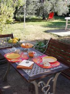 a picnic table with plates of food on it at Calicantus bed and breakfast in Albenga