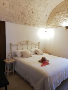 Postel nebo postele na pokoji v ubytování Trulli Bosco Selva
