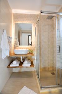 a bathroom with a sink and a shower at Meltemi Studios in Vasiliki