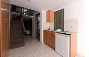 a kitchen with a staircase leading to a stair case at Dagris Villa Studios in Kamari +49 photos
