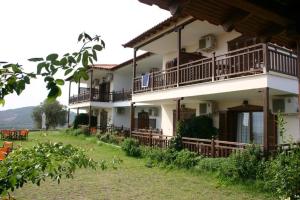 a building with balconies on the side of it at Studios Erotokritos in Ammouliani