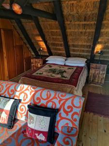 Un dormitorio con una cama y un sofá en una habitación. en Chilli Moon B&B, en Stilbaai