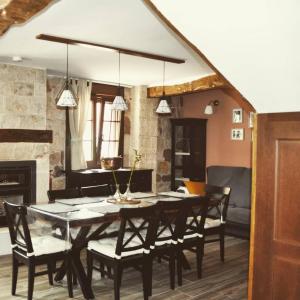 a dining room with a table and chairs at Casa Rural La Genciana VALMALA in Valmala