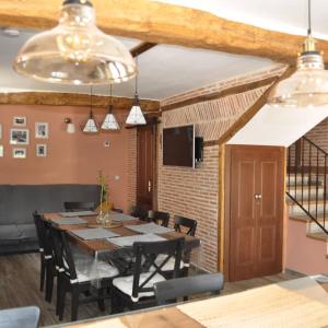 a dining room with a long table and chairs at Casa Rural La Genciana VALMALA in Valmala