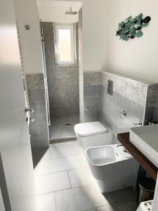 a bathroom with a toilet and a sink and a shower at Cielo&Mare affittacamere in La Spezia