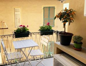 a balcony with two chairs and potted plants on it at Cielo&Mare affittacamere in La Spezia