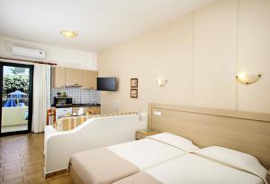 a hotel room with a bed and a kitchen at Lili Apartments,oasis 2,5 km from Hania center in Parigoría +29 photos