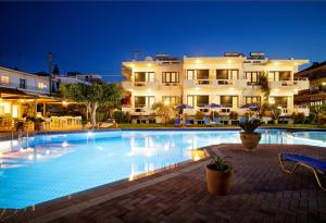 a large swimming pool in front of a building at Lili Apartments,oasis 2,5 km from Hania center in Parigoría
