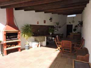 - un salon avec une cheminée, une table et des chaises dans l'établissement La Bellotita-Gáldar, à Gáldar