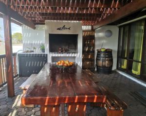 an outdoor table with a bowl of fruit on it at Chilli Moon B&B in Stilbaai