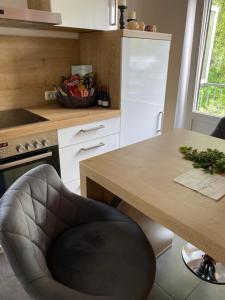 a kitchen with a table and a chair next to a counter at Apartment Kleine Kremper in Glückstadt