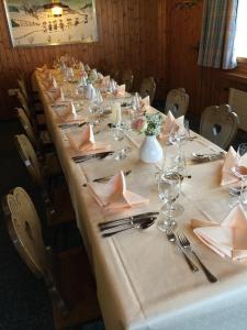 a long table with glasses and napkins on it at Landgasthof Schäfle in Sankt Peterzell