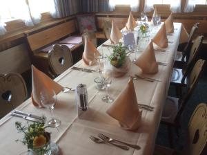 a long table with napkins on it in a restaurant at Landgasthof Schäfle in Sankt Peterzell