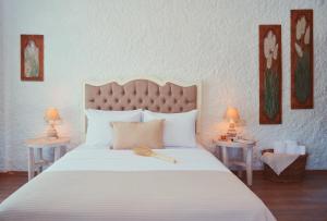 a bedroom with a large white bed with two tables at Rijeka Alaçatı in Cesme