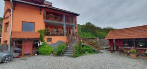 a building with a staircase in front of it at Pension Norbert in Sighişoara