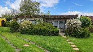 a house with a grass yard with a house at Bärenklau in Neustadt in Holstein