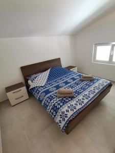 a bedroom with a bed with two towels on it at Apartments Victoria in Savudrija