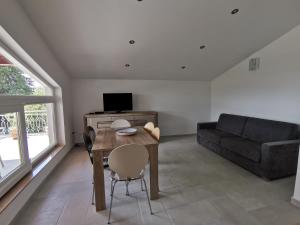 a living room with a table and a couch at Apartments Victoria in Savudrija