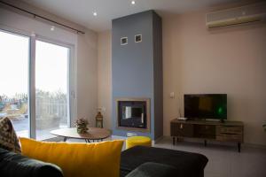 a living room with a couch and a tv at Villa Filyra in Faraklata