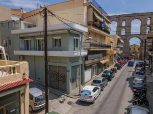a street with cars parked on the side of a building at Tompazi 2 in Kavala