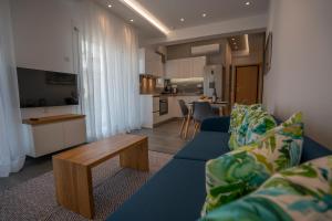 a living room with a blue couch and a table at Tompazi 2 in Kavala