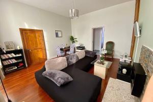 a living room with a couch and a table at Appartement : Le petit paradis de la Loire in La Charité-sur-Loire