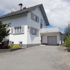 Uma casa branca com uma entrada à frente. em Ferienhaus Hämmerle´s em Lustenau