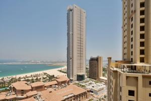 a view of a city with a beach and buildings at Fabulous Studio with Stunning Sea View by MK2 in Dubai