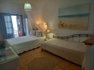 a bedroom with two beds and a window at Stefanos Katsaros Studios in Skala