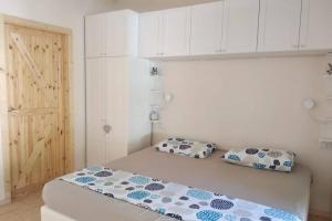 a bedroom with a bed with two pillows on it at Serenity Cottage Feriolo in Baveno