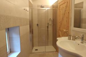 a bathroom with a shower and a sink at Serenity Cottage Feriolo in Baveno +35 photos
